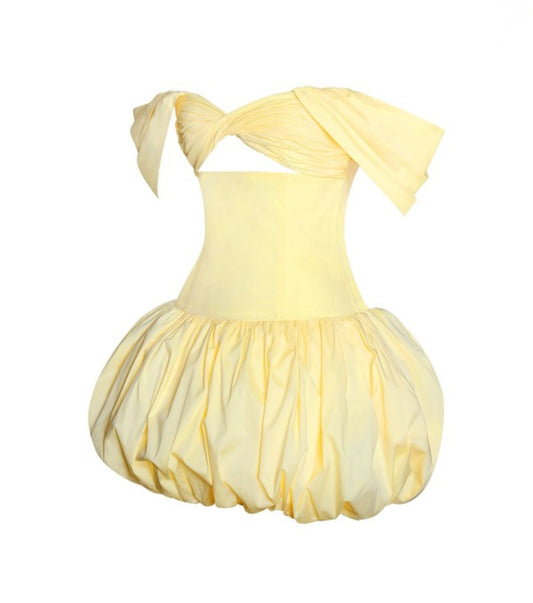 Yellow dress with a pleated skirt on a white background